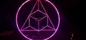 Image of Ricardo River's Sacred Sum. A glowing pink circle encloses a triangle which encloses a cube.